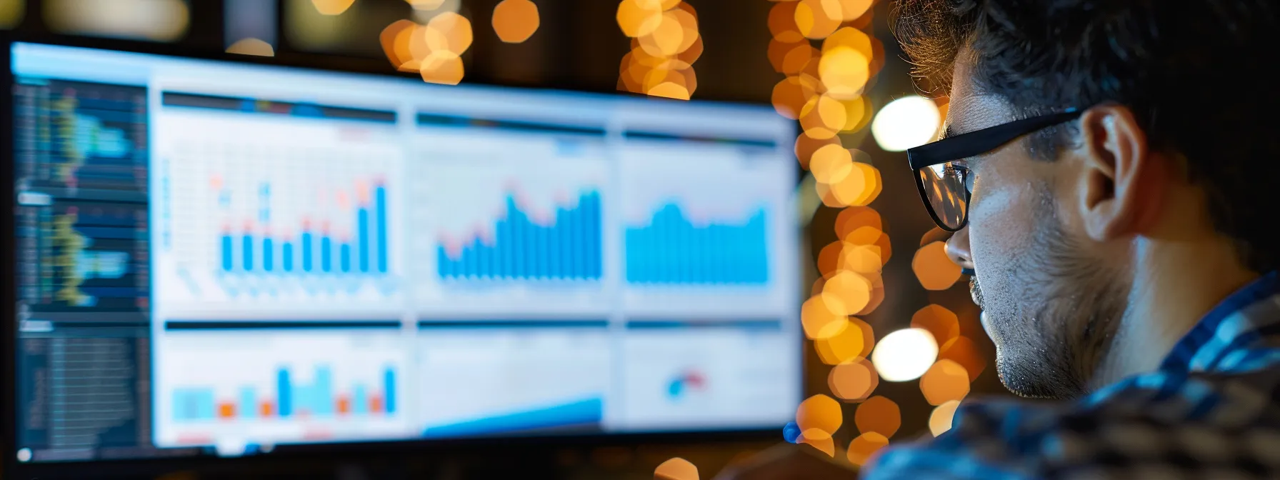 Man looking at graphs and figures produced by top technology expense management software